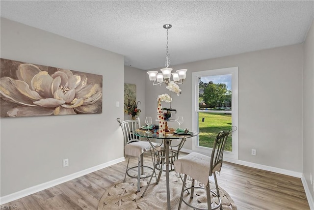 3905 Stonebridge Ct, Chesapeake, VA 23321 - dining space featuring wood finished floors, a textured ceiling, and a chandelier