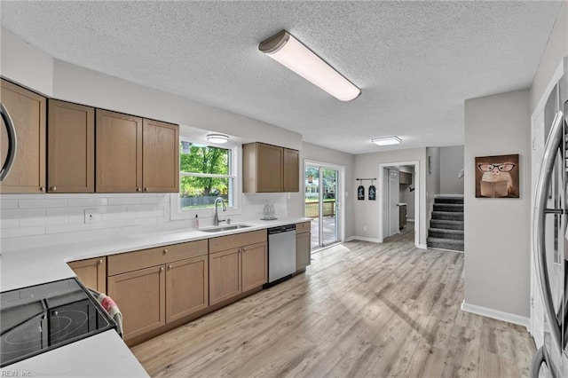 3905 Stonebridge Ct, Chesapeake, VA 23321 - kitchen with stainless steel appliances, light wood-style floors, light countertops, tasteful backsplash, and brown cabinetry