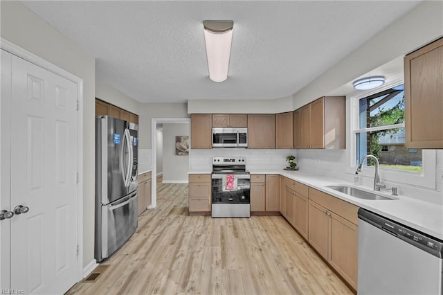 3905 Stonebridge Ct, Chesapeake, VA 23321 - kitchen with stainless steel appliances, backsplash, light countertops, light wood-style floors, and a textured ceiling