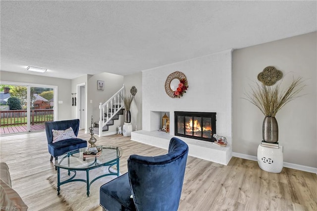 3905 Stonebridge Ct, Chesapeake, VA 23321 - living area with a textured ceiling, wood finished floors, stairs, and a fireplace