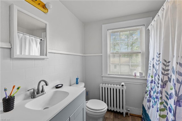 5 Rex Ave, Portsmouth, VA 23702 - bathroom featuring radiator heating unit, vanity, tile walls, wood finished floors, and a shower with shower curtain