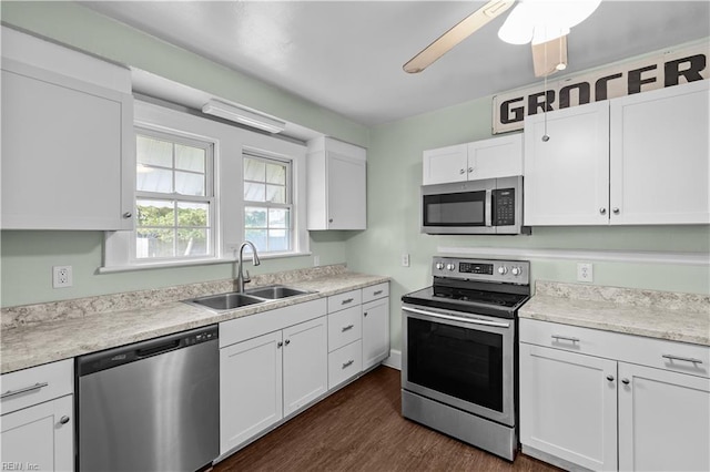 5 Rex Ave, Portsmouth, VA 23702 - kitchen featuring appliances with stainless steel finishes, white cabinets, light countertops, dark wood finished floors, and a ceiling fan