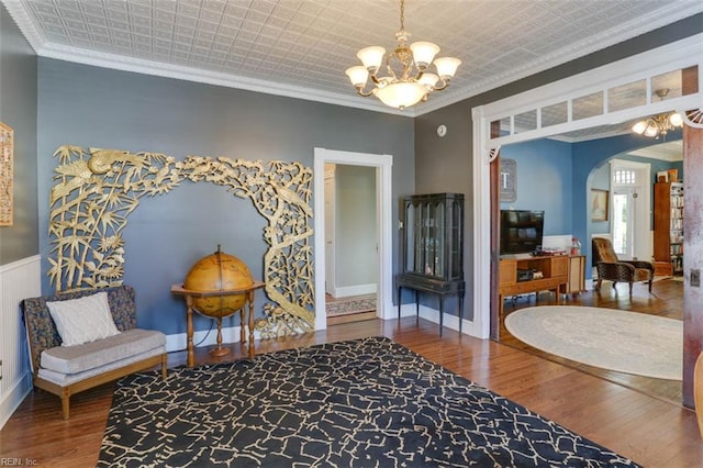122 S Willard Ave, Hampton, VA 23663 - sitting room with crown molding, a chandelier, arched walkways, wood finished floors, and an ornate ceiling