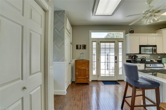 122 S Willard Ave, Hampton, VA 23663 - kitchen featuring appliances with stainless steel finishes, dark wood-style flooring, white cabinets, and ceiling fan