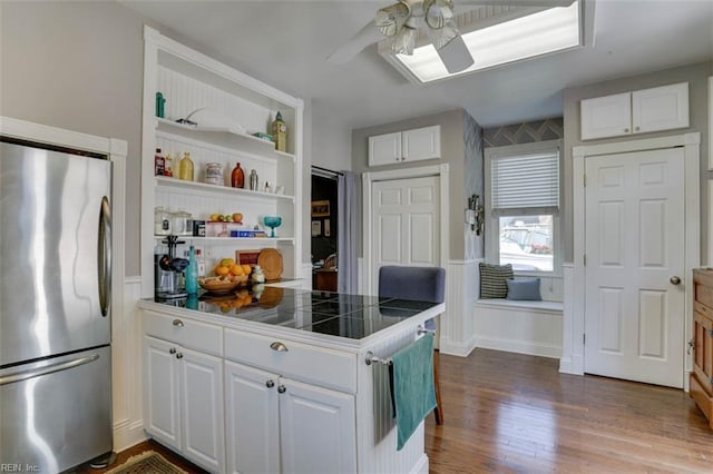 122 S Willard Ave, Hampton, VA 23663 - kitchen with stainless steel refrigerator, a ceiling fan, white cabinets, dark wood finished floors, and open shelves