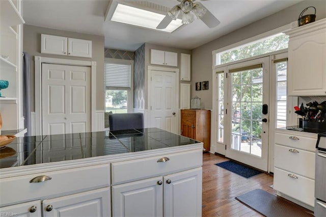 122 S Willard Ave, Hampton, VA 23663 - kitchen with dark countertops, white cabinets, wood finished floors, and a ceiling fan