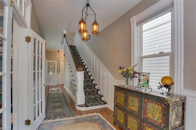 122 S Willard Ave, Hampton, VA 23663 - entryway with wood finished floors, stairs, french doors, a chandelier, and wainscoting