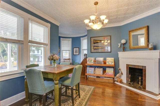 122 S Willard Ave, Hampton, VA 23663 - dining room featuring a chandelier, wood finished floors, an ornate ceiling, crown molding, and a tile fireplace