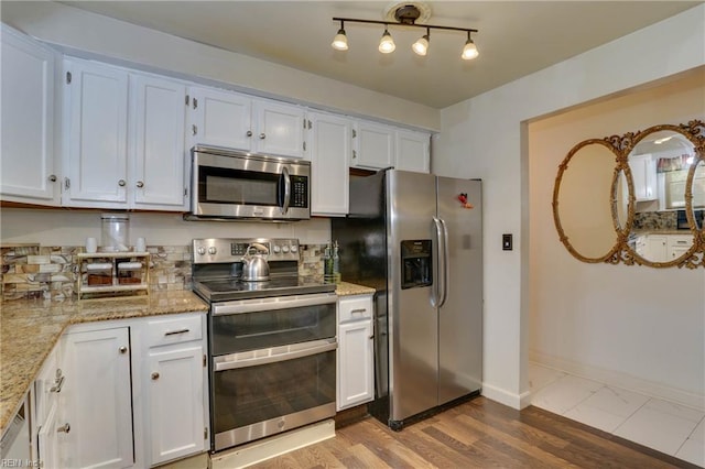 6285 Buckley Hall Rd, Cobbs Creek, VA 23035 - kitchen featuring stainless steel appliances, light stone countertops, white cabinets, and wood finished floors