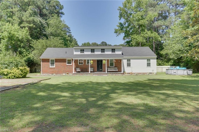 6285 Buckley Hall Rd, Cobbs Creek, VA 23035 - back of property featuring covered porch, an outdoor pool, a lawn, and brick siding
