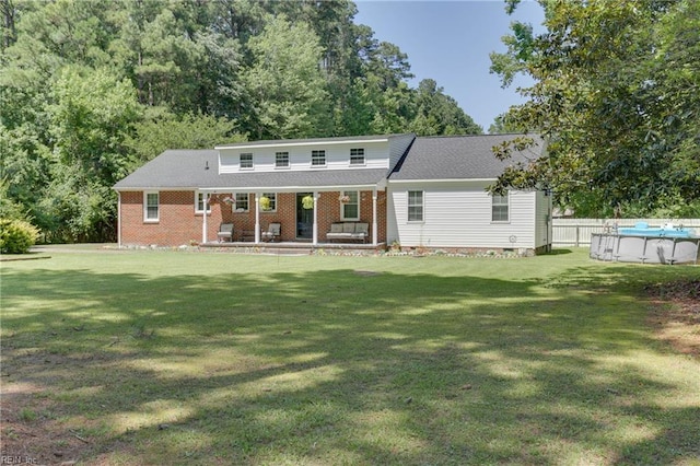 6285 Buckley Hall Rd, Cobbs Creek, VA 23035 - rear view of property featuring a porch, an outdoor pool, and a yard