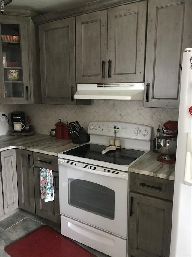 3500 Dana Ln, Virginia Beach, VA 23452 - kitchen with white appliances, under cabinet range hood, tasteful backsplash, and light countertops