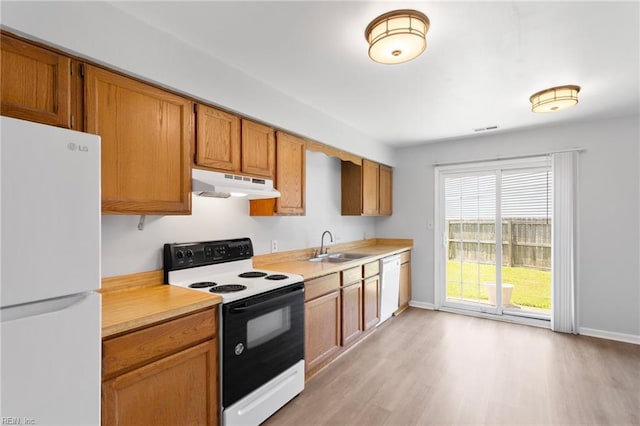 1117 Tibbetstown Ct, Virginia Beach, VA 23454 - kitchen with white appliances, under cabinet range hood, light countertops, light wood-type flooring, and brown cabinetry