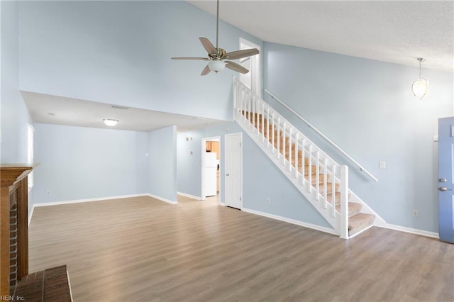 1117 Tibbetstown Ct, Virginia Beach, VA 23454 - unfurnished living room with stairs, a ceiling fan, wood finished floors, high vaulted ceiling, and a fireplace