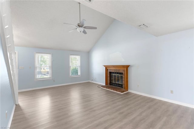 1117 Tibbetstown Ct, Virginia Beach, VA 23454 - unfurnished living room featuring a ceiling fan, wood finished floors, a brick fireplace, a textured ceiling, and high vaulted ceiling