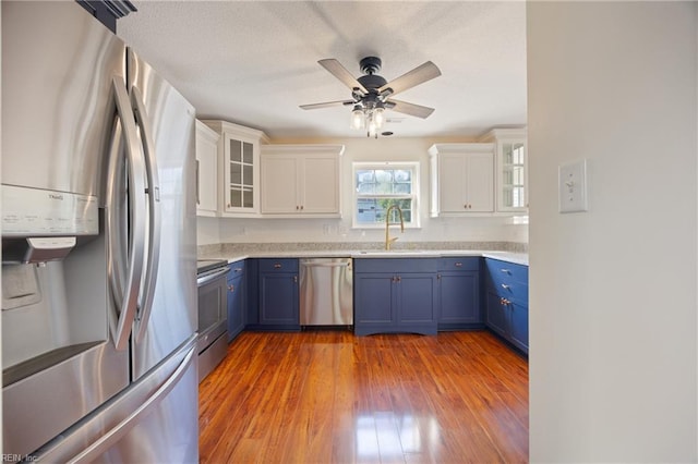3015 Beech Grove Ln, Suffolk, VA 23435 - kitchen featuring stainless steel appliances, blue cabinetry, white cabinetry, and ceiling fan