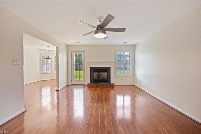 3015 Beech Grove Ln, Suffolk, VA 23435 - unfurnished living room with wood finished floors, a ceiling fan, and a glass covered fireplace