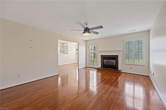 3015 Beech Grove Ln, Suffolk, VA 23435 - unfurnished living room featuring ceiling fan, wood finished floors, and a glass covered fireplace