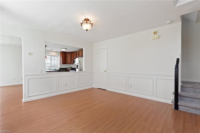 5405 Kiawah Ct, Virginia Beach, VA 23462 - unfurnished living room with light wood-type flooring, stairway, and wainscoting