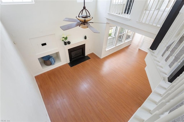 5405 Kiawah Ct, Virginia Beach, VA 23462 - unfurnished living room featuring a fireplace with flush hearth, wood finished floors, a ceiling fan, and a towering ceiling