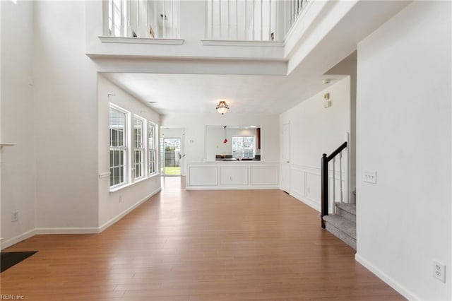 5405 Kiawah Ct, Virginia Beach, VA 23462 - unfurnished living room featuring stairs, wood finished floors, and a high ceiling