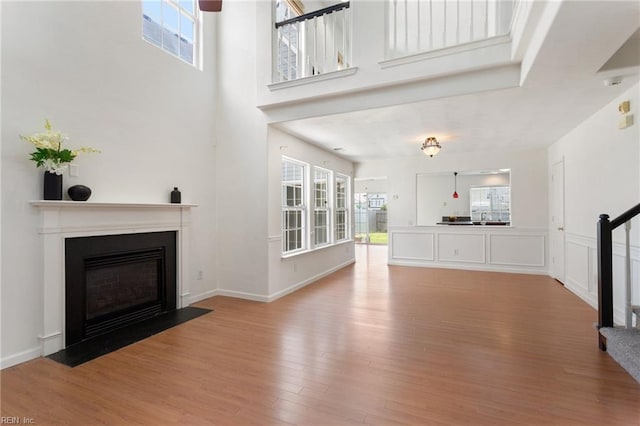 5405 Kiawah Ct, Virginia Beach, VA 23462 - unfurnished living room with healthy amount of natural light, wood finished floors, a fireplace with flush hearth, and a high ceiling