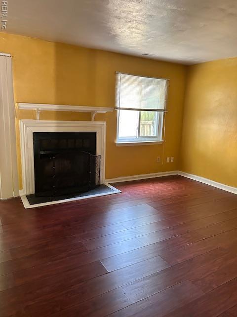 5207 Richard Rd, Virginia Beach, VA 23462 - unfurnished living room with a fireplace with raised hearth and dark wood-style floors