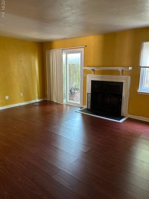 5207 Richard Rd, Virginia Beach, VA 23462 - unfurnished living room featuring a fireplace with raised hearth and hardwood / wood-style flooring