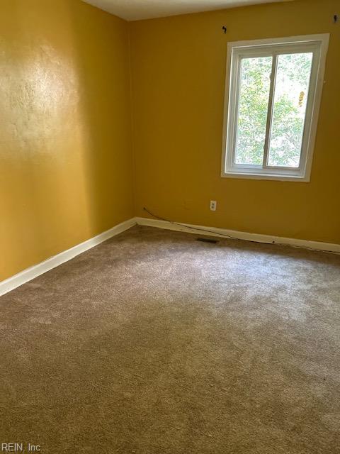 5207 Richard Rd, Virginia Beach, VA 23462 - spare room featuring baseboards and dark colored carpet