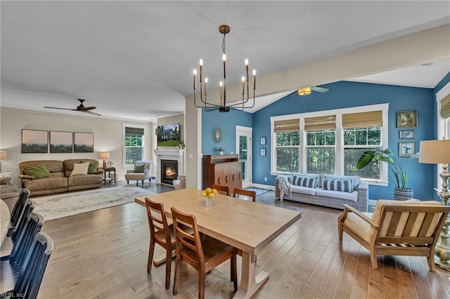 112 Gleneagles, Smithfield, VA 23430 - dining space featuring a warm lit fireplace, a ceiling fan, hardwood / wood-style floors, a chandelier, and lofted ceiling
