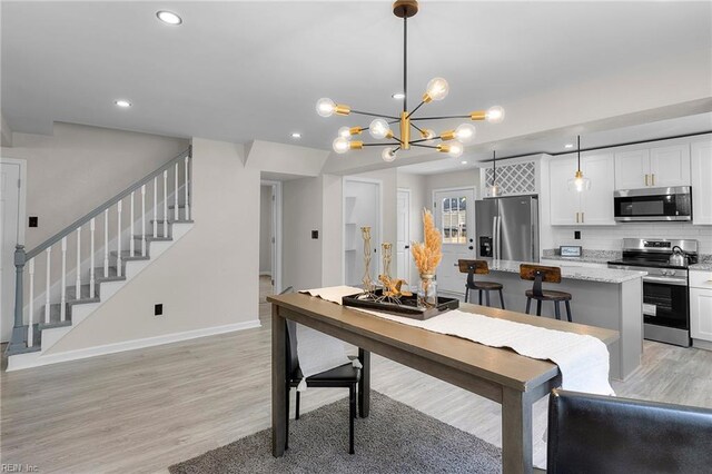 21 Rodgers Pl, Portsmouth, VA 23702 - dining area with recessed lighting, stairway, light wood-style flooring, and a chandelier