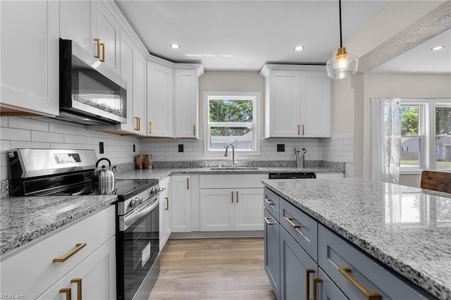 21 Rodgers Pl, Portsmouth, VA 23702 - kitchen featuring appliances with stainless steel finishes, healthy amount of natural light, white cabinetry, and recessed lighting