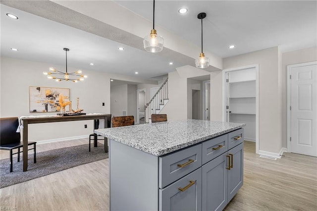21 Rodgers Pl, Portsmouth, VA 23702 - kitchen with light wood-type flooring, hanging light fixtures, light stone counters, a center island, and recessed lighting