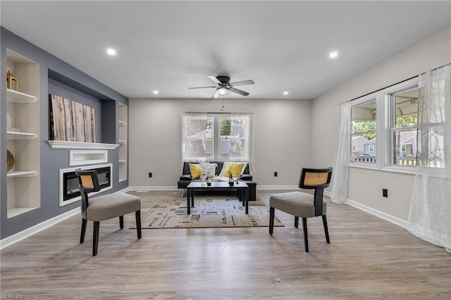 21 Rodgers Pl, Portsmouth, VA 23702 - living area with built in shelves, recessed lighting, wood finished floors, ceiling fan, and a glass covered fireplace