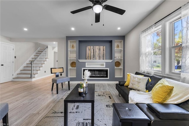 21 Rodgers Pl, Portsmouth, VA 23702 - living area featuring stairs, wood finished floors, a glass covered fireplace, recessed lighting, and a ceiling fan