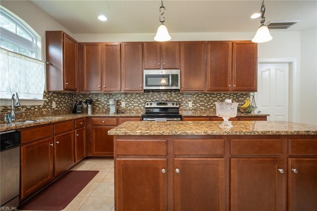 1304 Kemp Bridge Dr, Chesapeake, VA 23320 - kitchen with stainless steel appliances, backsplash, light stone countertops, and hanging light fixtures