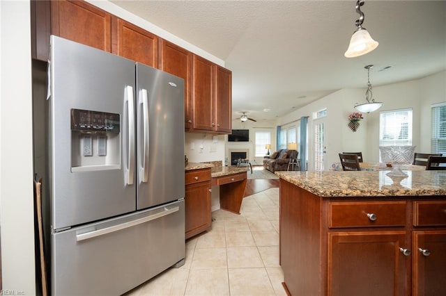 1304 Kemp Bridge Dr, Chesapeake, VA 23320 - kitchen featuring stainless steel fridge, a fireplace, plenty of natural light, and light tile patterned flooring