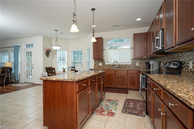 1304 Kemp Bridge Dr, Chesapeake, VA 23320 - kitchen with black electric range, light tile patterned floors, stainless steel microwave, decorative backsplash, and recessed lighting