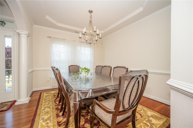 1304 Kemp Bridge Dr, Chesapeake, VA 23320 - dining space featuring ornate columns, a chandelier, wood finished floors, a raised ceiling, and ornamental molding