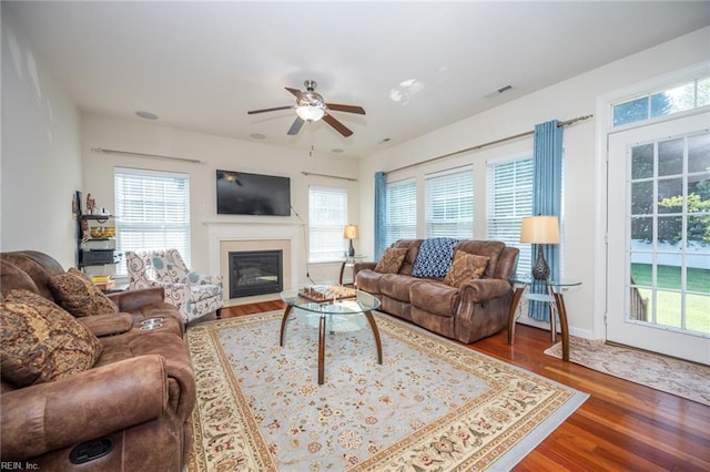 1304 Kemp Bridge Dr, Chesapeake, VA 23320 - living area with wood finished floors, ceiling fan, healthy amount of natural light, and a fireplace with flush hearth