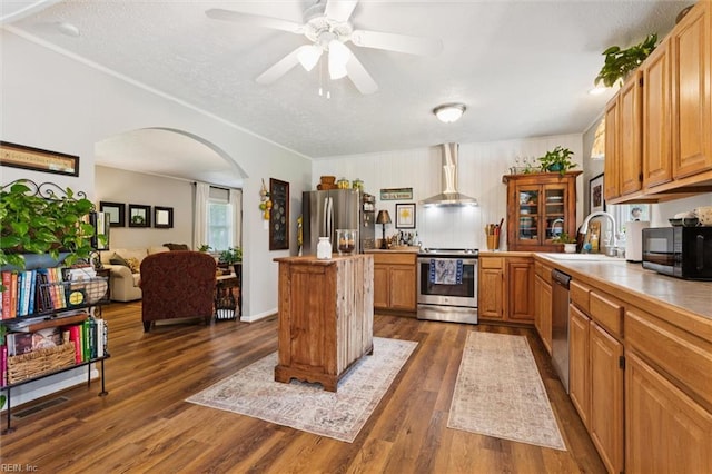 278 Mallard Dr, Hardyville, VA 23070 - kitchen featuring appliances with stainless steel finishes, arched walkways, a kitchen island, dark wood-style flooring, and a textured ceiling