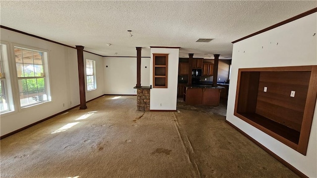 4371 Providence Rd, Hayes, VA 23072 - unfurnished living room featuring ornate columns, crown molding, carpet, and a textured ceiling