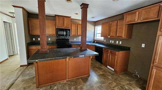 4371 Providence Rd, Hayes, VA 23072 - kitchen featuring black appliances, ornate columns, brown cabinetry, crown molding, and dark countertops