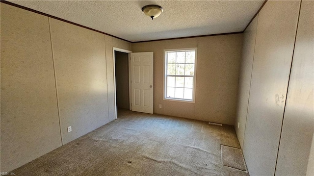 4371 Providence Rd, Hayes, VA 23072 - carpeted spare room featuring crown molding, a textured ceiling, and a decorative wall