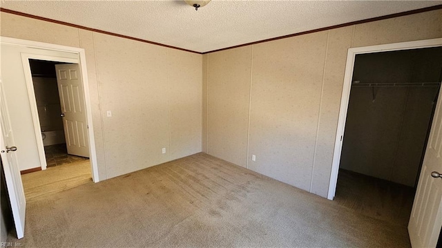 4371 Providence Rd, Hayes, VA 23072 - unfurnished bedroom featuring crown molding, a spacious closet, a closet, carpet floors, and a decorative wall