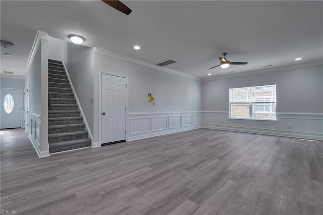 115 Pescara Ln, Newport News, VA 23601 - unfurnished living room featuring a ceiling fan, ornamental molding, stairs, wood finished floors, and a decorative wall