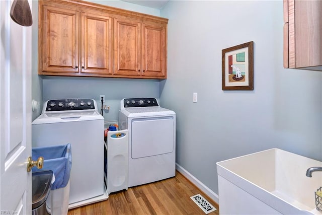 116 W Links, Williamsburg, VA 23188 - laundry room with separate washer and dryer, cabinet space, and light wood-style flooring