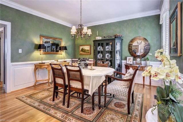 116 W Links, Williamsburg, VA 23188 - dining space with wood finished floors, a chandelier, ornamental molding, and a wainscoted wall