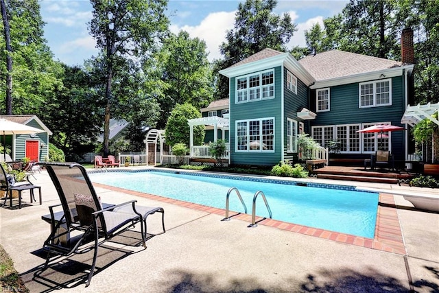 116 W Links, Williamsburg, VA 23188 - outdoor pool featuring a wooden deck, a pergola, a patio, and an outbuilding