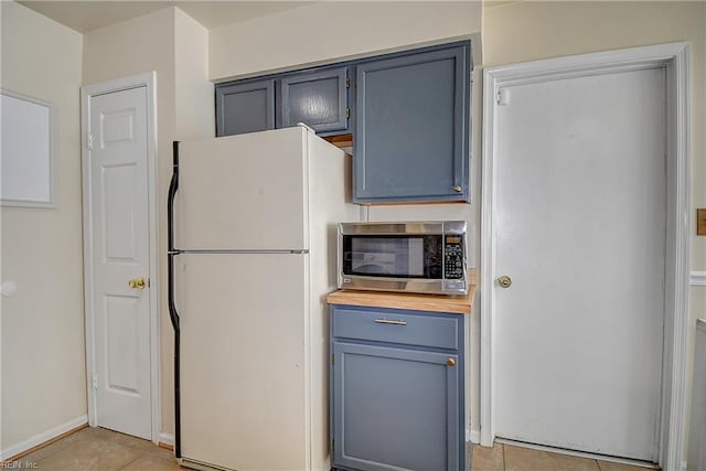2561 Elon Dr, Virginia Beach, VA 23454 - kitchen featuring freestanding refrigerator, stainless steel microwave, light tile patterned flooring, and gray cabinets